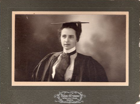 Studio portrait of a woman in graduation cap and gown