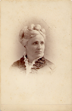 Studio portrait of a woman in graduation cap and gown